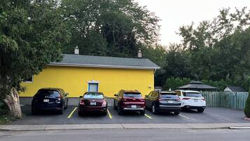 A yellow building with a garage parking area.