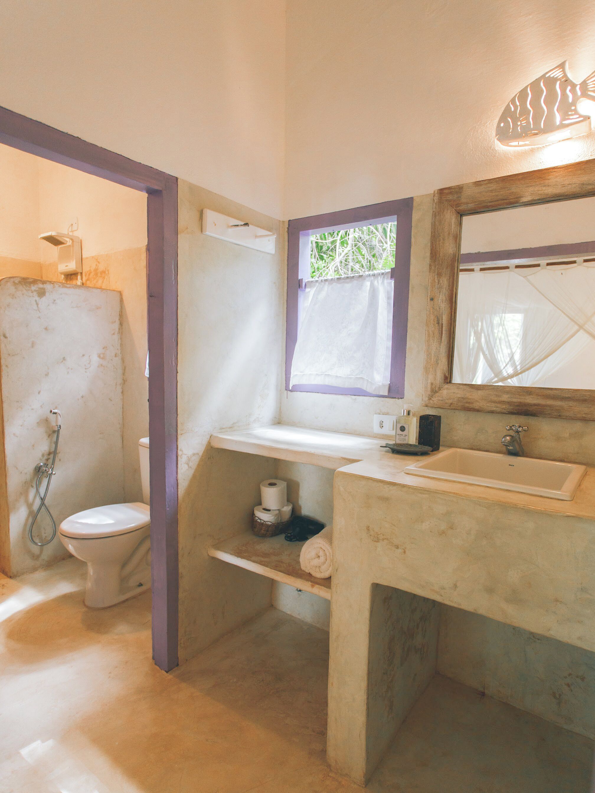 A bathroom with a toilet, a sink, and a shower.