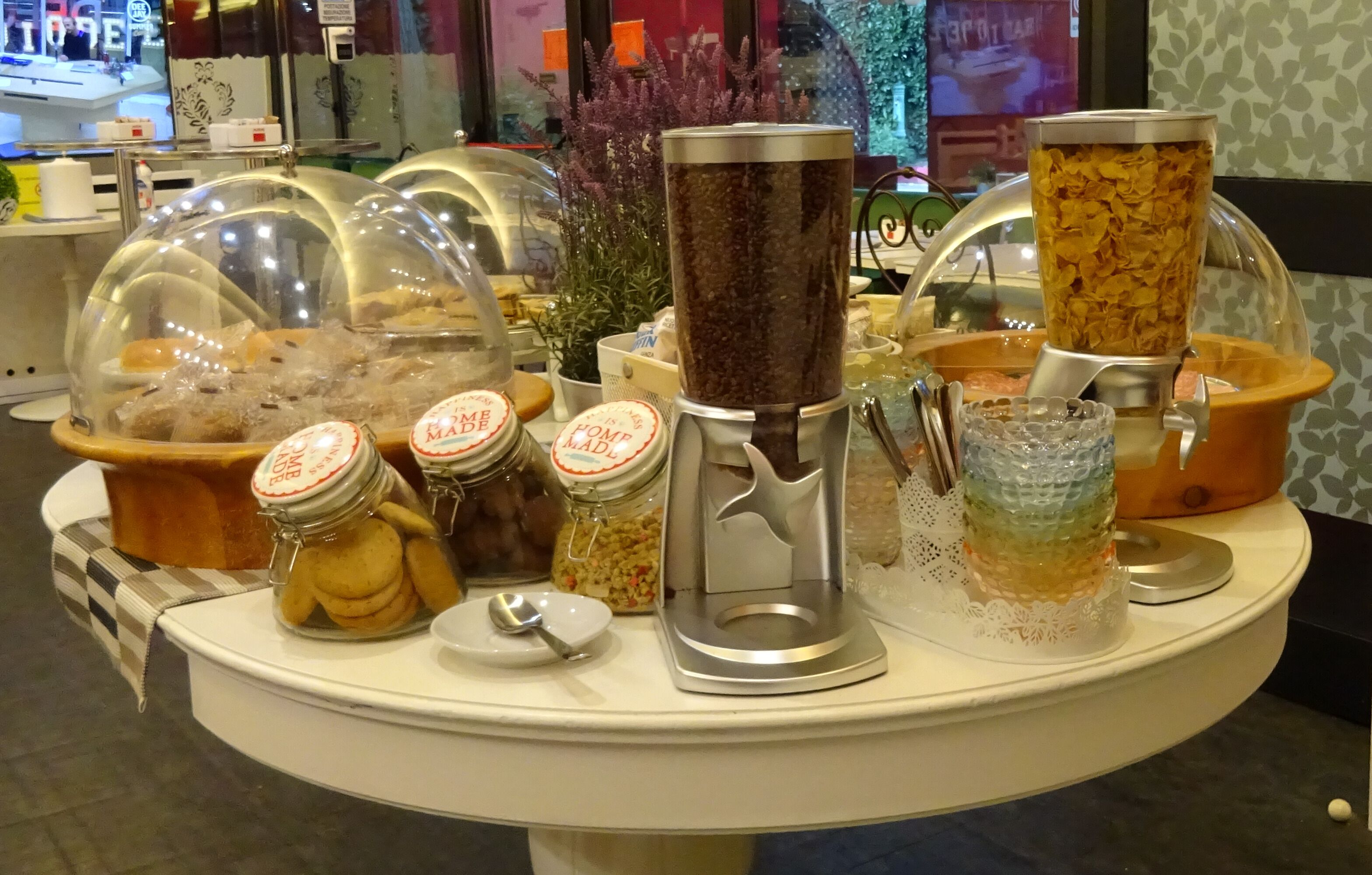 A breakfast buffet with various food items and a coffee machine.