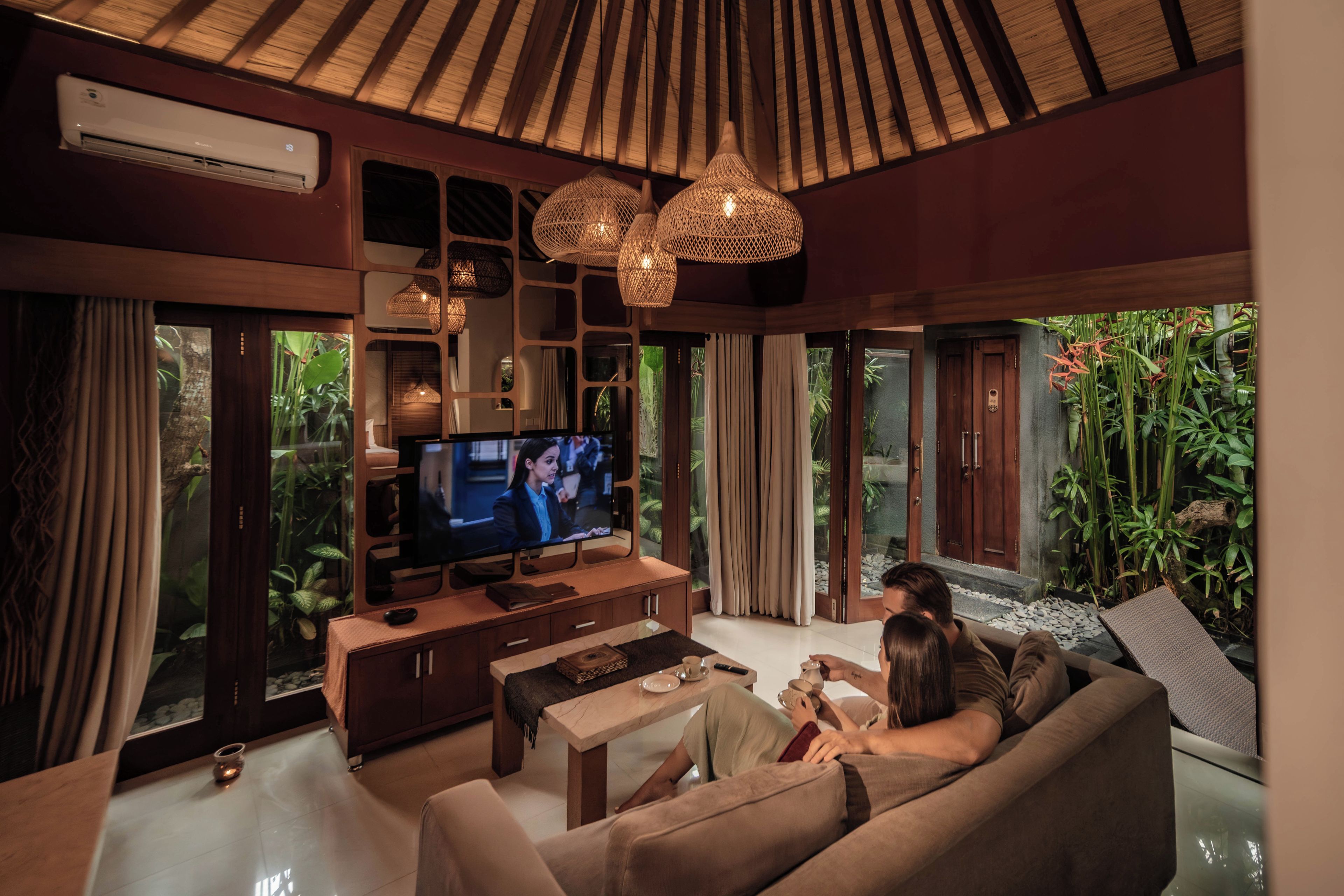 A modern living room with a television, sofa, and coffee table.