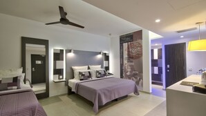 A modern hotel room with a bed, bedside tables, a ceiling fan, and a bathroom with a mirror and towel rack. - Hotel Valentina (St. Julian's)