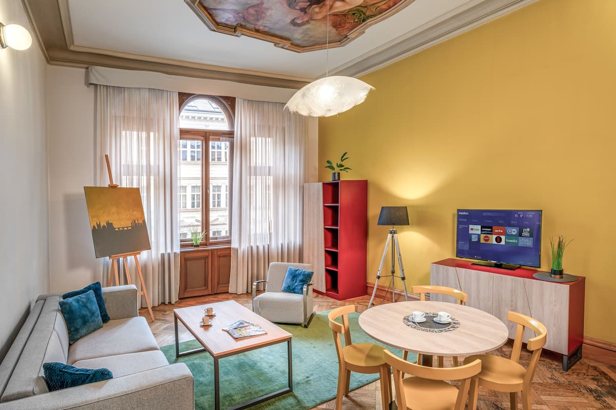 A living room with a sofa, coffee table, and a TV on a stand.
