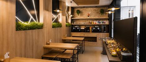 A modern cafe interior with wooden tables and chairs, a coffee bar with espresso machines, and a view of the city through large windows.