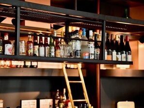 A bar with shelves stocked with various bottles of alcohol, including wine and spirits. - ibis Styles Brest Centre Port (Brest)