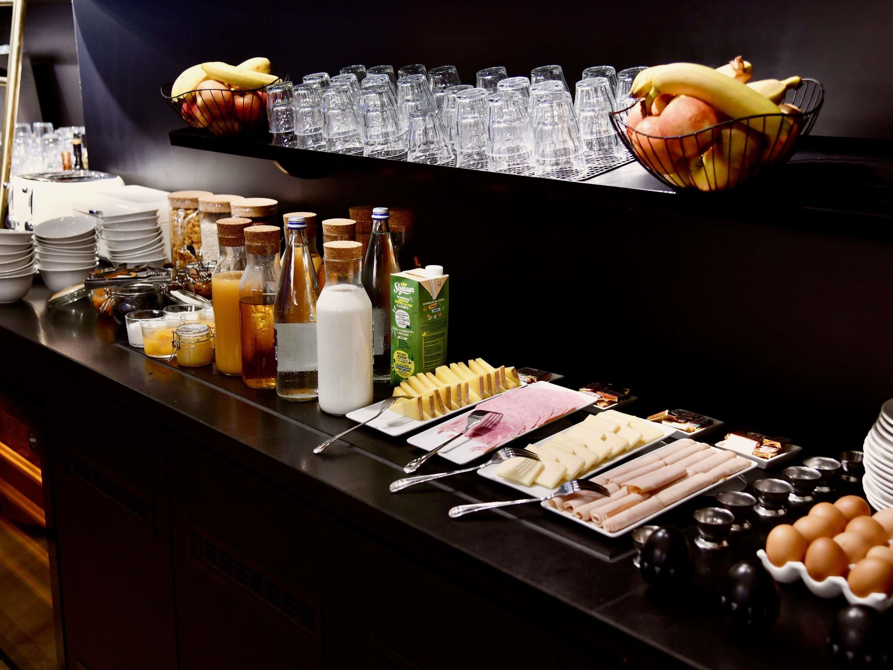 A buffet with various food items and beverages.
