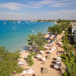On the beach, white sand, beach umbrellas, beach towels