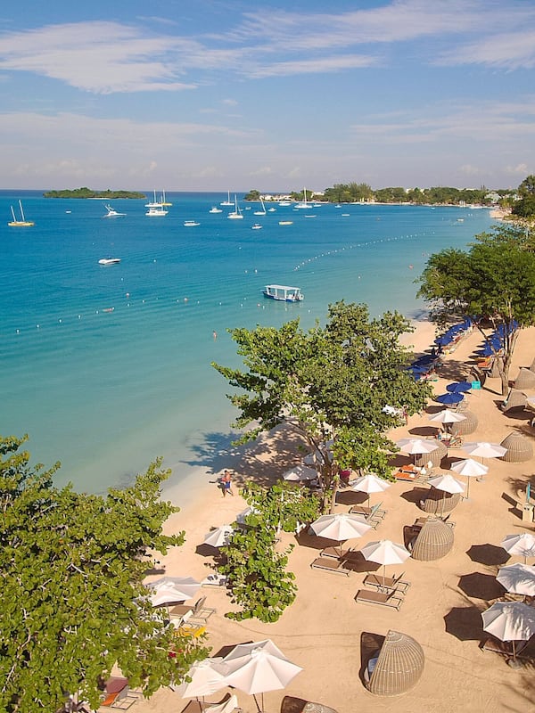 On the beach, white sand, beach umbrellas, beach towels