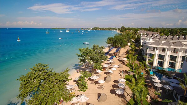On the beach, white sand, beach umbrellas, beach towels