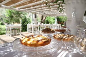 A table with desserts under a white gazebo. - Maison d'Enrì (Gallipoli)