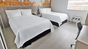 A hotel room with two beds, a desk, a chair, a nightstand, and a window. - GHL Hotel Neiva (Neiva)