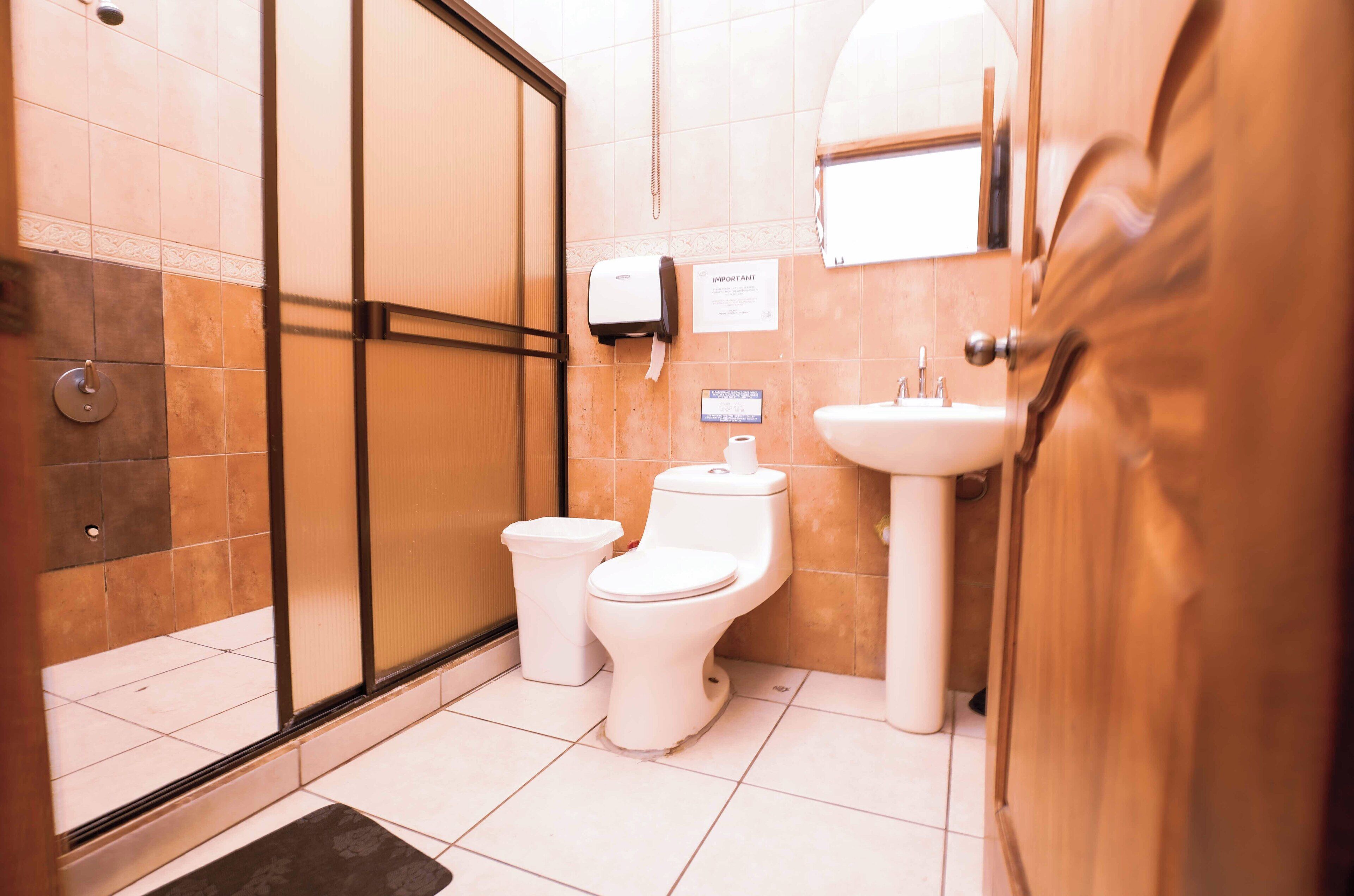 A bathroom with a toilet, bidet, and sink.