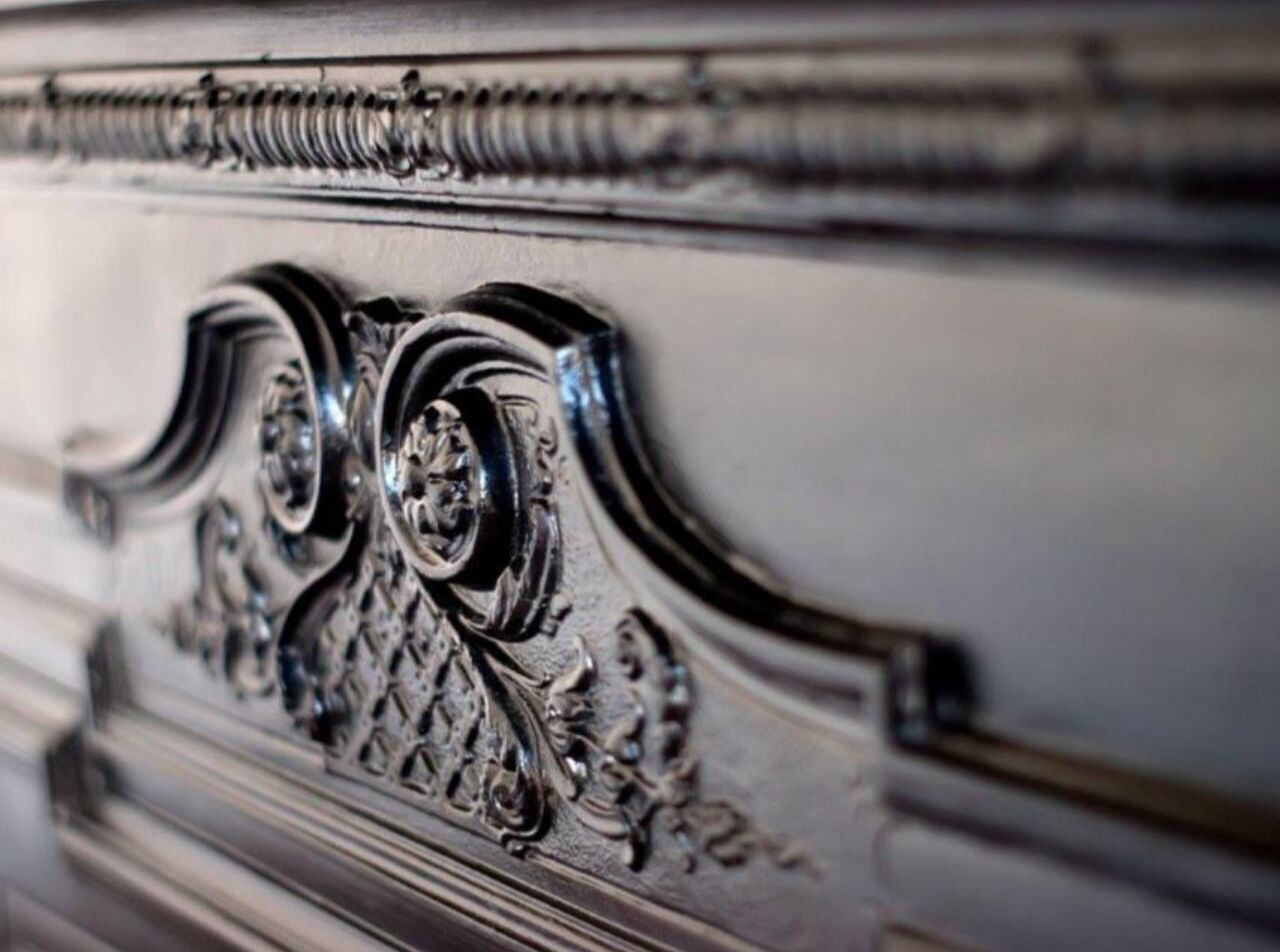 A close-up of a metallic, ornate design with intricate patterns and a central circular element.