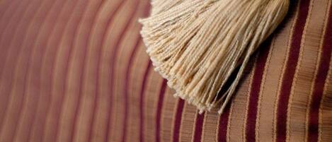 A close-up of a striped fabric with a tassel.