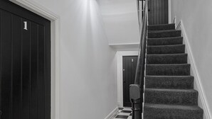 A staircase with carpeted steps and a black railing, leading to a door marked with the number 3. - Blackpool Abode - 20 Bairstow Street (Blackpool)