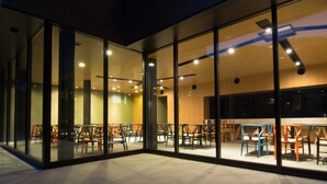 A modern interior with glass walls, multiple seating areas, and ceiling lights. - Koharu Resort Hotel & Suites (Hakuba)