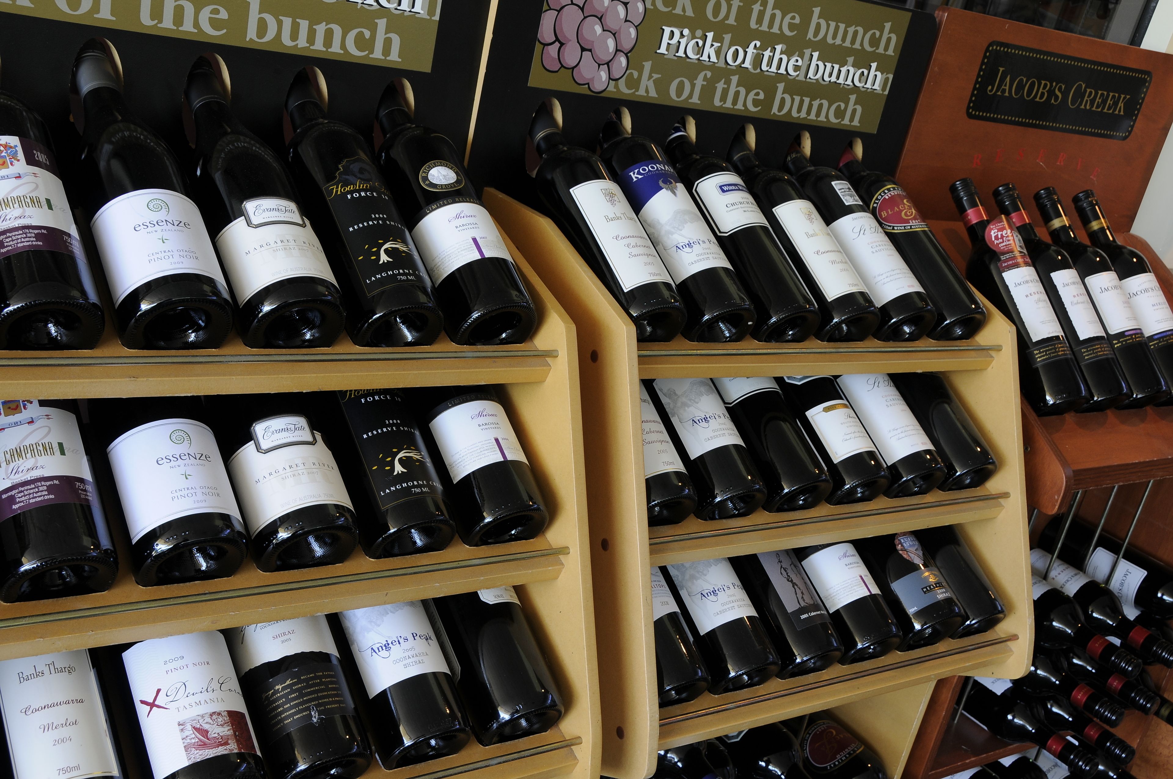 A wine rack with various bottles of wine.