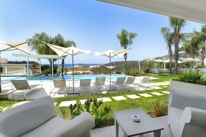Relax by the serene pool surrounded by lush greenery and scenic views.