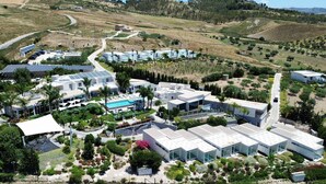 An aerial view of a modern resort with multiple buildings, a swimming pool, and landscaped gardens. - Doric Eco Boutique Resort & Spa - Sicily (Agrigento)