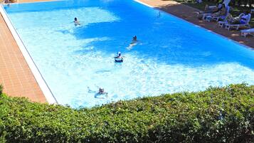 Seasonal outdoor pool, open 10:00 AM to 7:00 PM, pool umbrellas