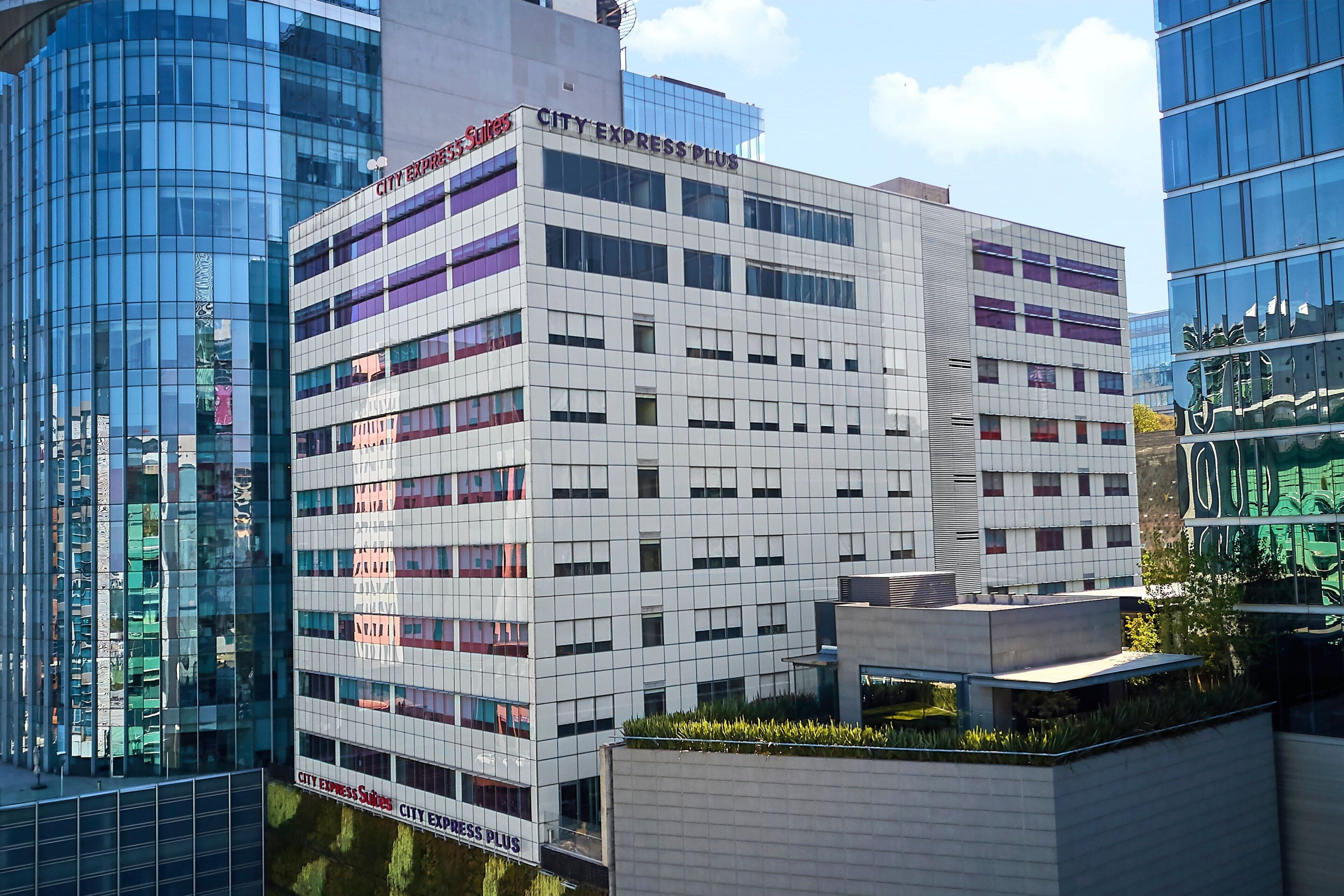 A modern building with the sign "CITY EXPRESS PLUS" on the facade.
