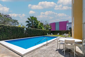 Outdoor pool, open 8:00 AM to 8:00 PM, pool loungers
