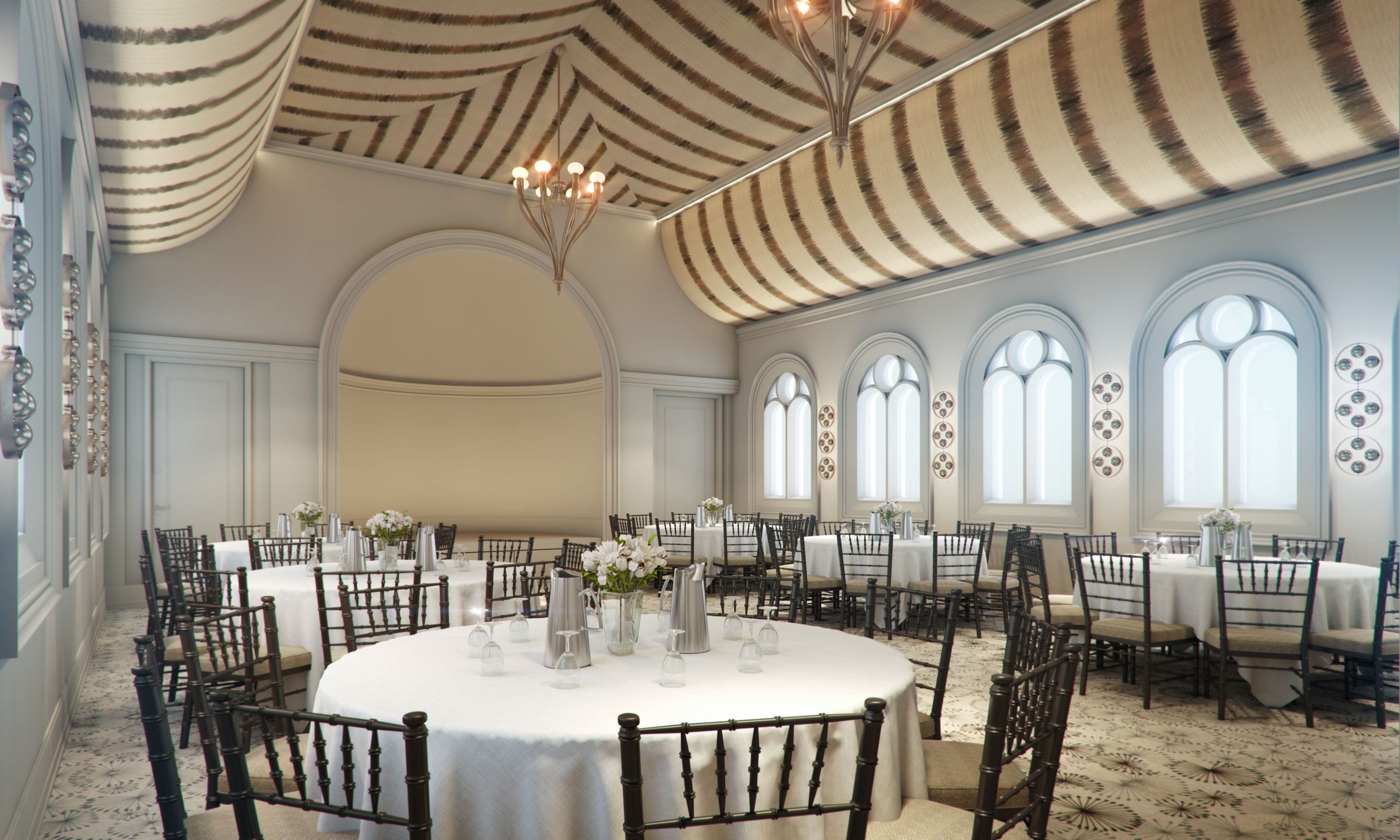 A banquet hall with round tables, chairs, and a high ceiling with striped patterns.