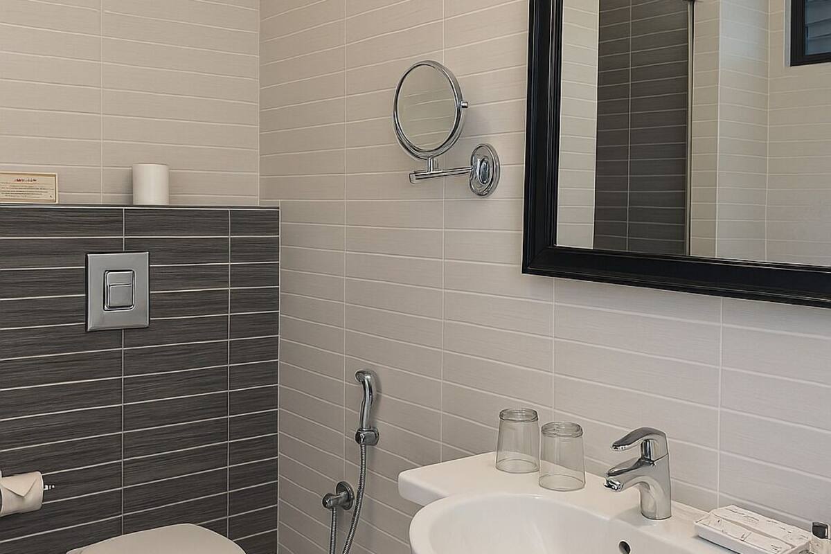 deluxe room | bathroom | shower, designer toiletries, hair dryer, slippers