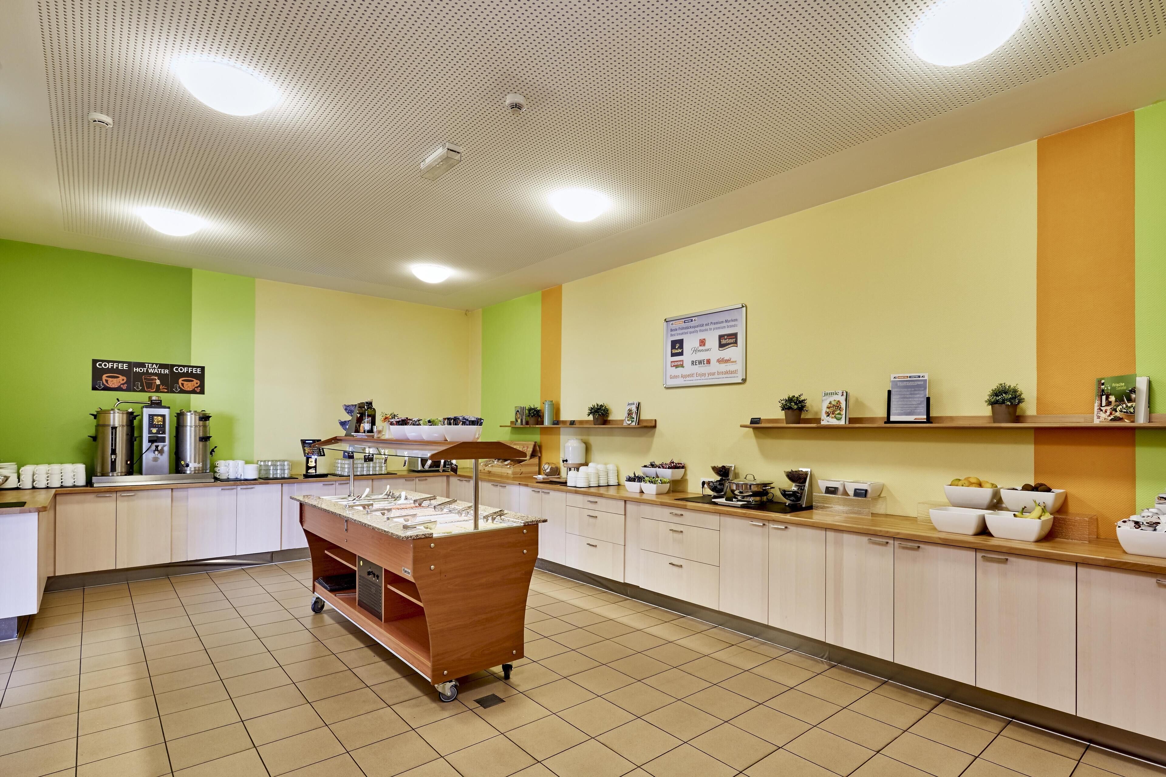 A buffet setup with various food items and a coffee station.