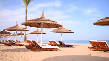 Private beach, beach umbrellas, beach towels, beach volleyball