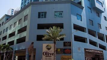 A multi-story building with a prominent sign for 'Olive Western The Olive' and 'Chappy's Lounge' on the ground floor.