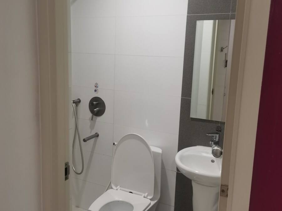 A modern bathroom with a toilet, bidet, and sink.