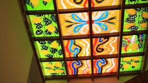A stained glass window with geometric patterns and fruit illustrations. - Hotel Edelweiss (Erice)