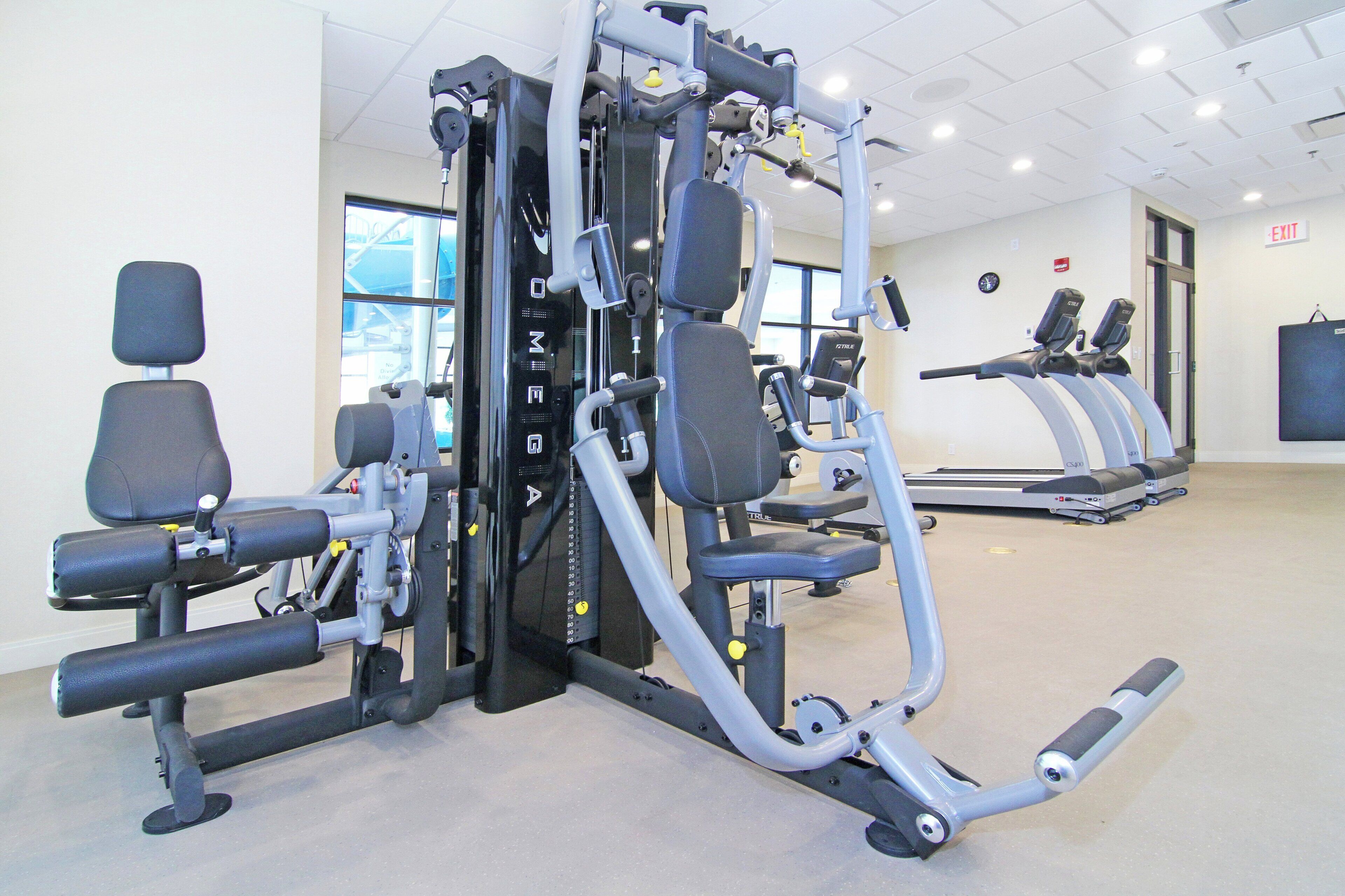 A gym with various exercise equipment, including weight machines and treadmills.