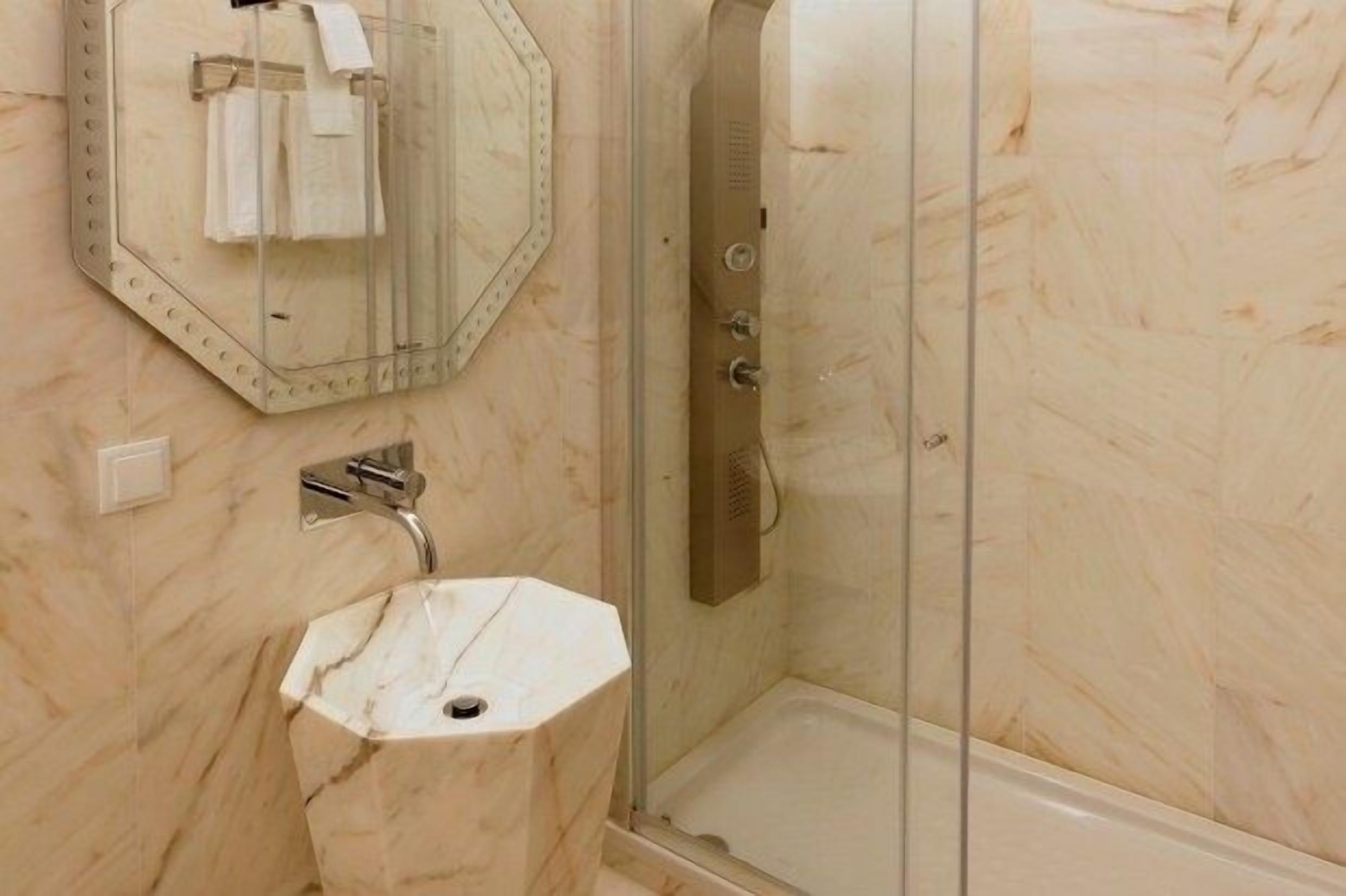 deluxe suite | bathroom | designer toiletries, hair dryer, bathrobes, slippers