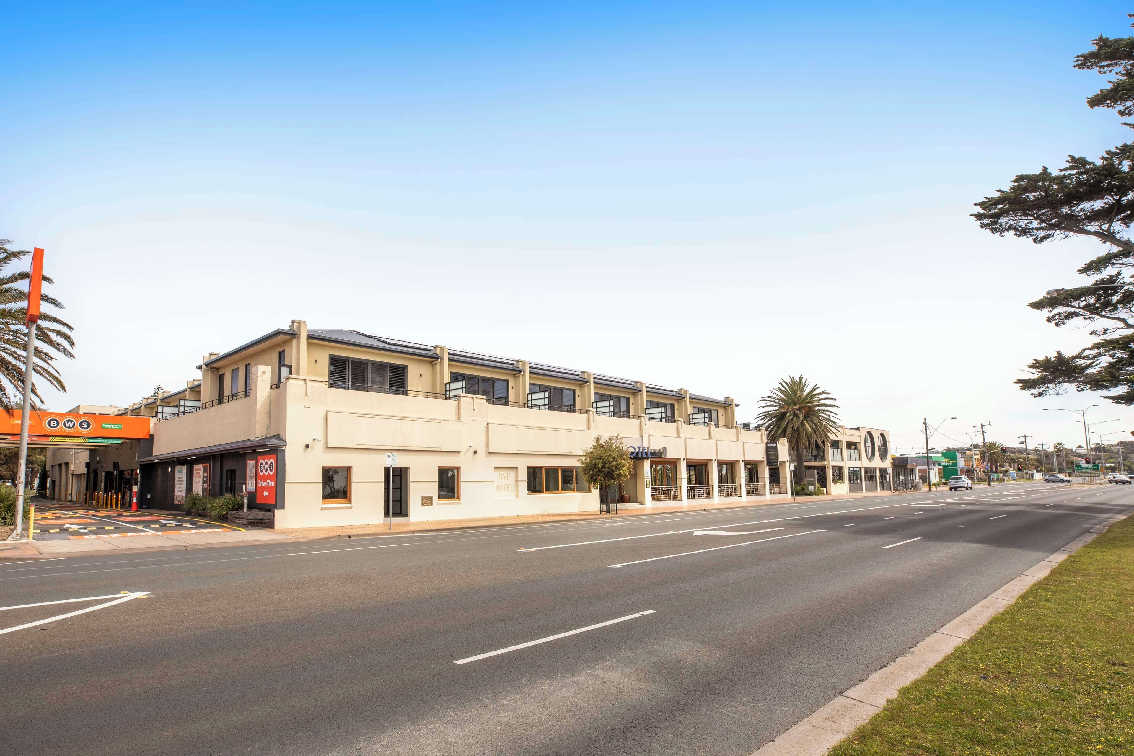 A multi-story building with a flat facade, large windows, and a ground-level entrance.