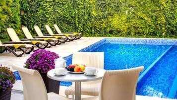 Seasonal outdoor pool, open 8 AM to 9 PM, pool umbrellas, pool loungers