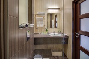 A modern bathroom with a wooden vanity, a glass shower enclosure, and a mirror above the sink. - Eco hotel Villa Pinia (Odesa)
