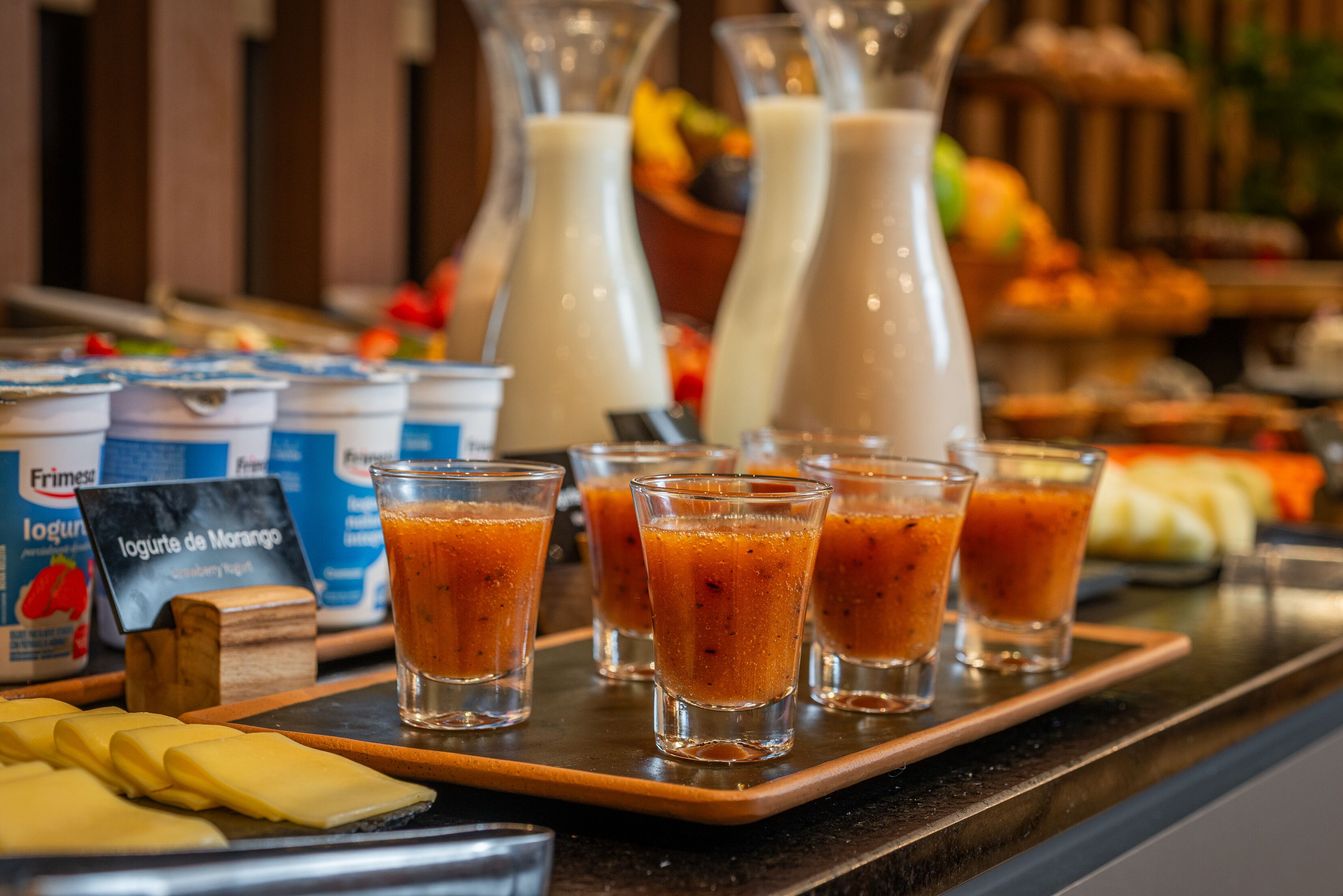 A breakfast buffet with various food items and drinks.