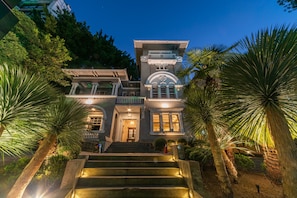 A grand building with multiple levels, a prominent entrance, and a staircase leading to the main entrance.