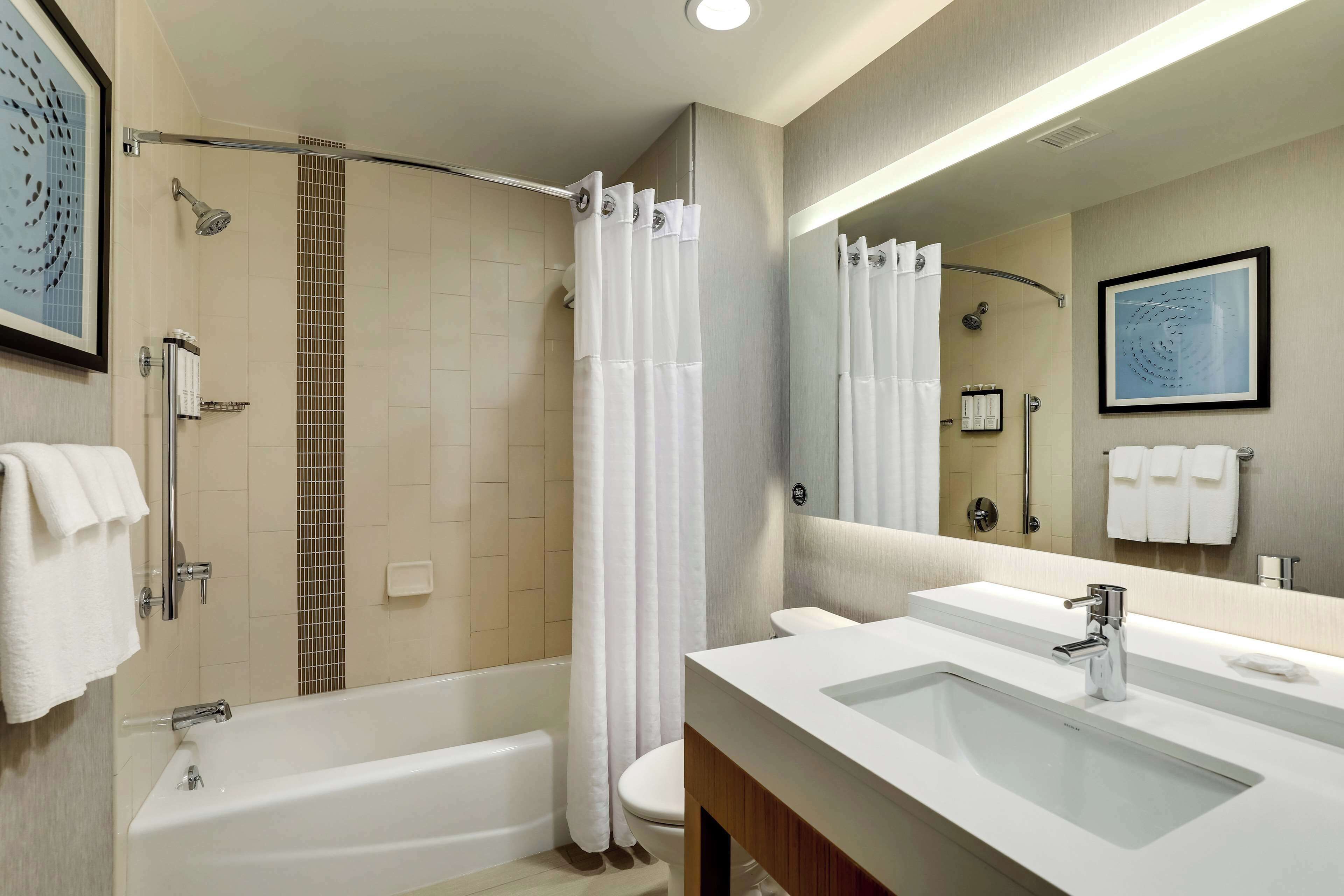 designer toiletries, hair dryer, towels, soap