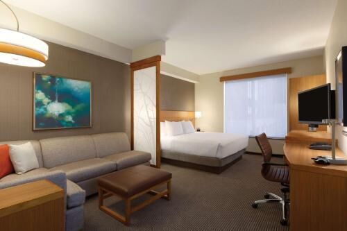 Premium bedding, desk, laptop workspace, blackout drapes