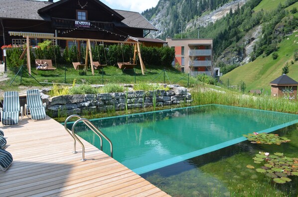 Seasonal outdoor pool, a natural pool - Hotel und Aparthotel Almrรถsl (Huettschlag)