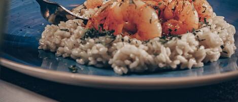 A plate of food with rice and shrimp.