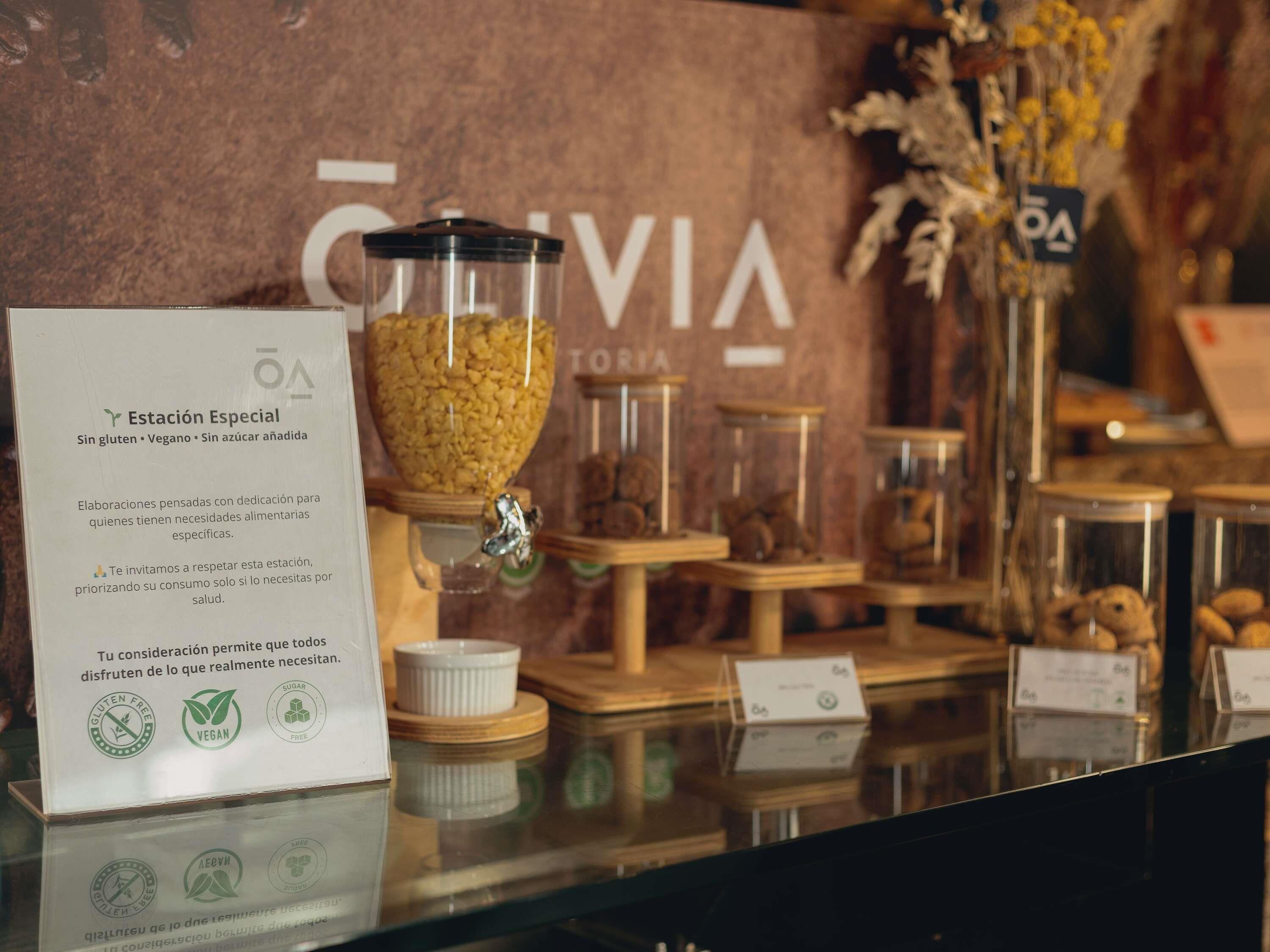 A food display with a sign indicating gluten-free, vegan, and sugar-free options.