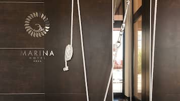 A modern interior with a dark wooden wall, a logo, and a rope swing.