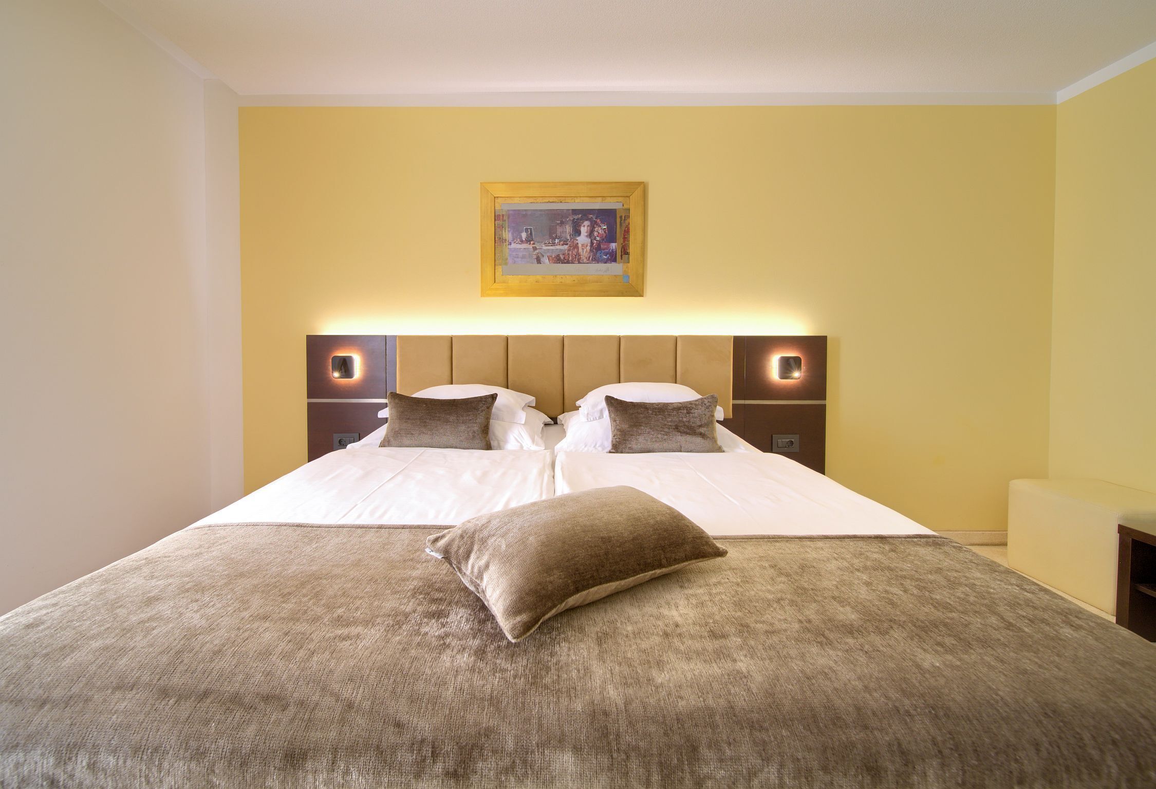 A double bed with a headboard, two bedside tables, and a single pillow.