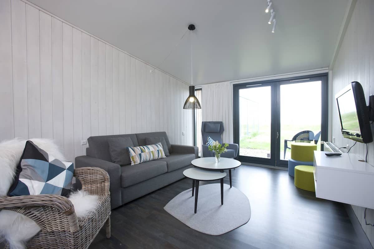 family apartment, multiple beds, partial sea view | living area | 22-inch flat-screen tv with cable channels, tv