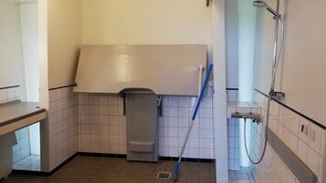 A bathroom with a shower, toilet, and sink.