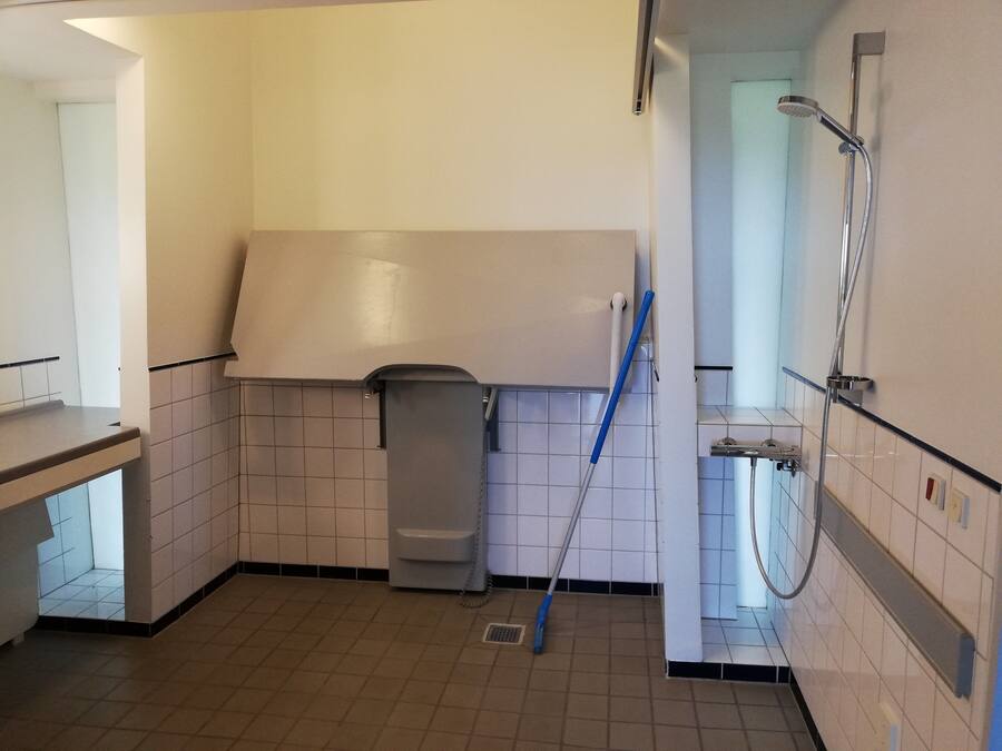 A bathroom with a shower, toilet, and sink.