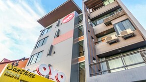 A multi-story hotel with balconies and air conditioning units. - Sunshine House (Chiang Mai)